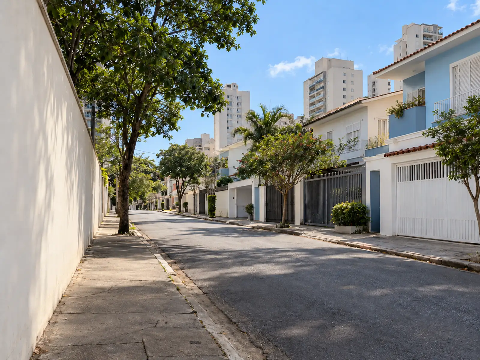 Rua residencial arborizada com casas e prédios, região atendida em Moema